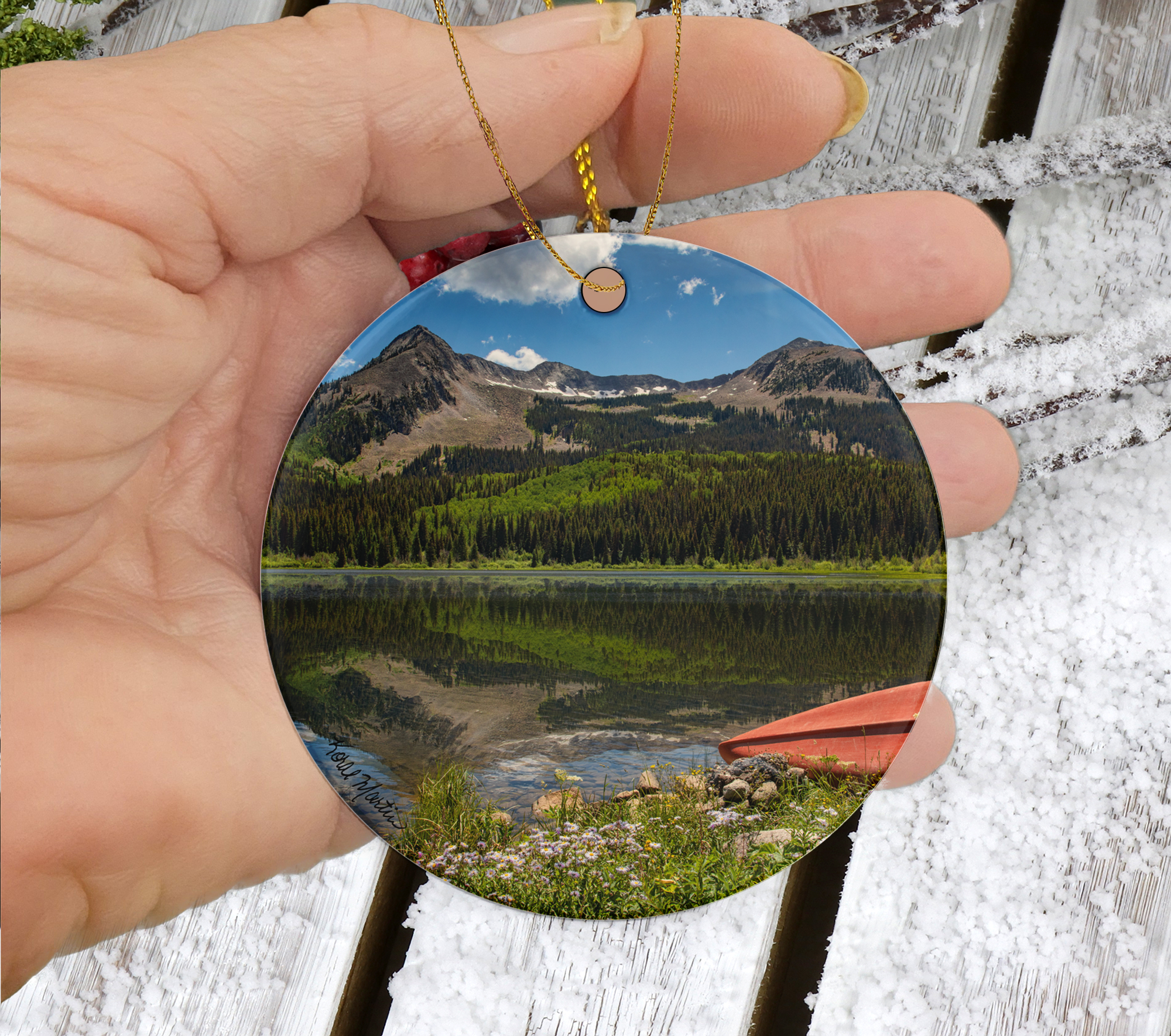 Ceramic Colorado Lake Christmas ornament featuring a red canoe and mountain reflections at Lost Lakes near Kebler Pass