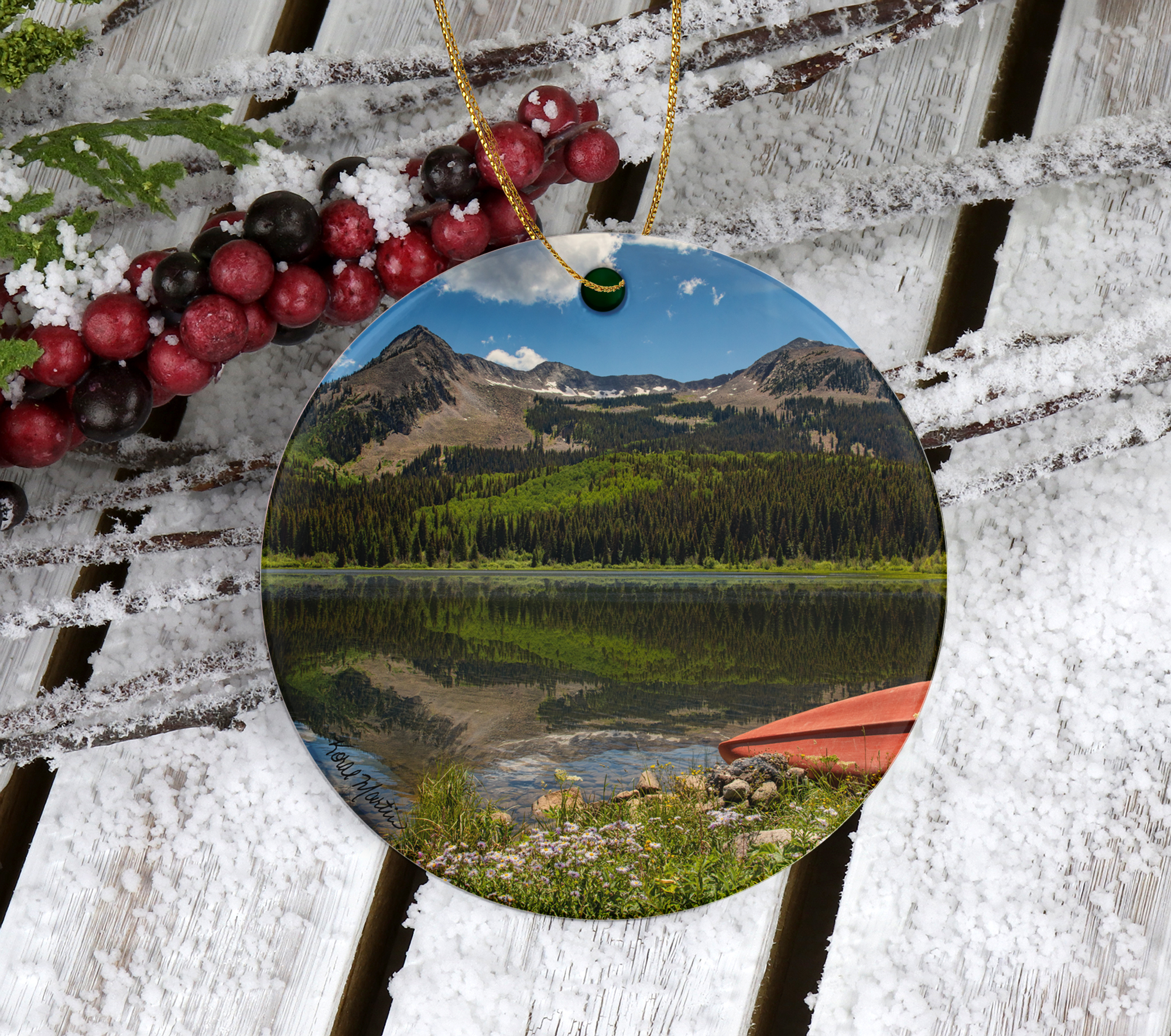 Ceramic Colorado Lake Christmas ornament featuring a red canoe and mountain reflections at Lost Lakes near Kebler Pass